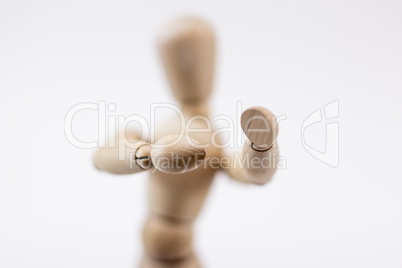 A wooden mannequin in a boxing position.