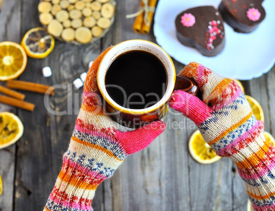 A cup of coffee in his hands,