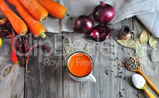 Carrot juice in an iron mug