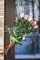 A bouquet of roses on the front door.