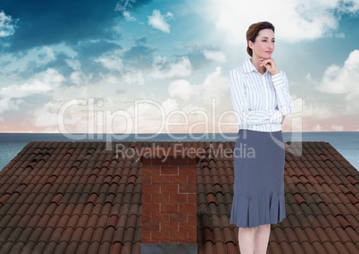 Businesswoman standing on Roof with chimney and ocean landscape