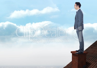 Businessman standing on Roof with chimney and blue sky