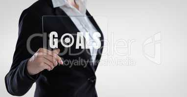 Business woman holding a glass with goals text