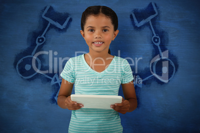 Composite image of portrait of cute smiling girl holding digital tablet