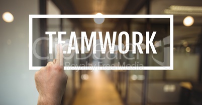 Hand interacting with teamwork business text against blurred background