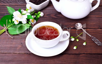 hot black tea in a white cup with a saucer