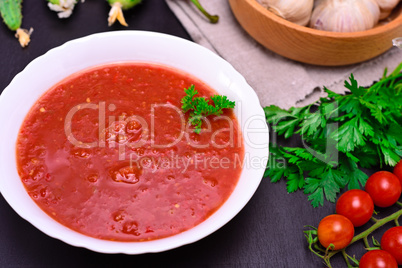 cold tomato soup gazpacho in a round white plate