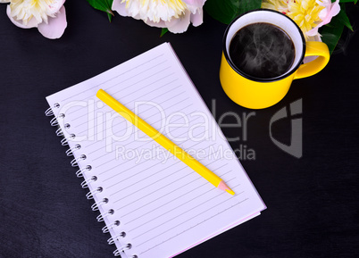 paper notebook with a yellow wooden pencil