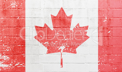 White brick wall with Canadian flag