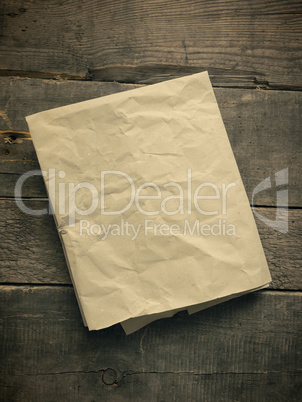 Crumpled paper on wood