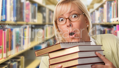 Beautiful Expressive Student or Teacher with Books in Library.