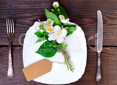 square white plate and iron cutlery