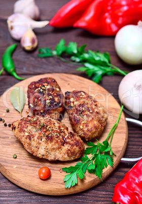 Meat cutlets on a wooden board