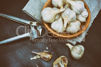 Harvest garlic in husk in a wooden bowl