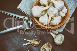 Harvest garlic in husk in a wooden bowl