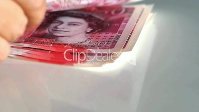 Woman counts for 50 pound banknotes