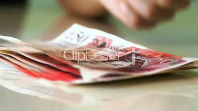 Woman counts for 50 pound banknotes