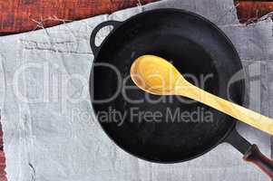 empty frying pan with a wooden spoon