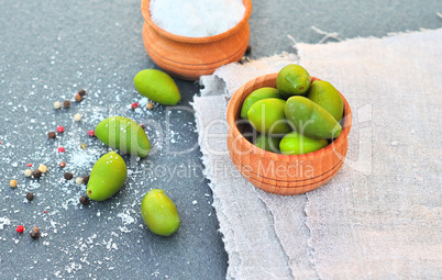 green olives in a wooden bowl