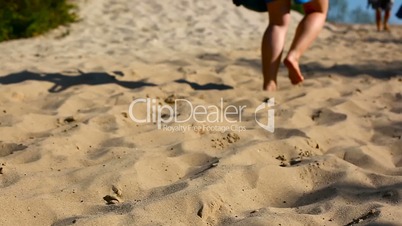 The girl is running along the sand.
