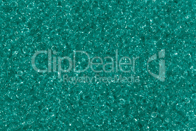 Shiny green seed beads background.