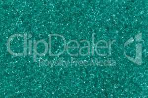 Shiny green seed beads background.
