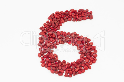 The number six, made by red stones.