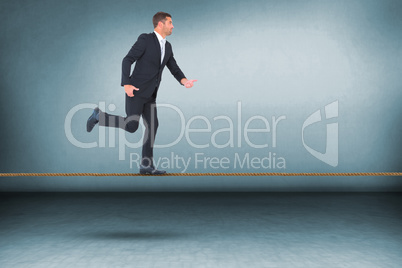 Composite image of businessman walking with his hands out