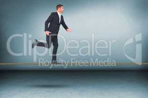 Composite image of businessman walking with his hands out