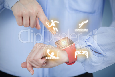 Composite image of midsection of businesswoman pointing at smart watch