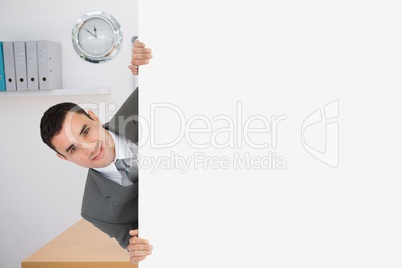 Business man holding blank card in office