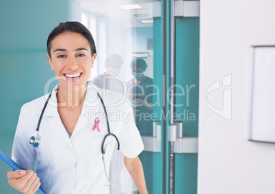 Doctor woman with breast cancer awareness ribbon