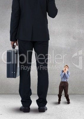 Scared small business man looking at a big business man