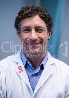 Doctor man with breast cancer awareness ribbon