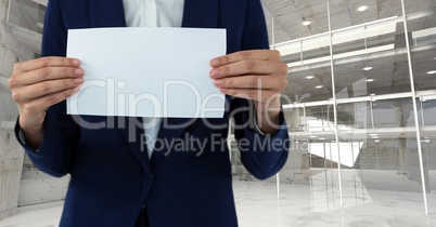 Business woman holding blank card in office