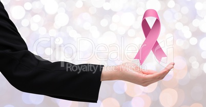 Open hand with pink ribbon for breast cancer awareness