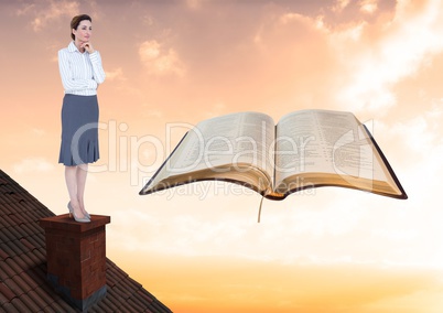 Woman on roof looking at book