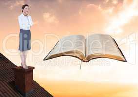 Woman on roof looking at book