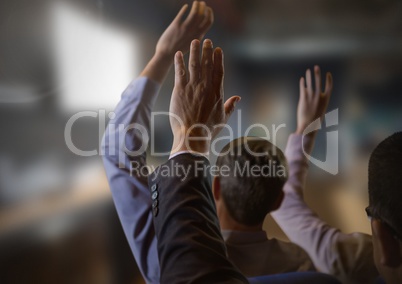 Business people with hands raised up at conference