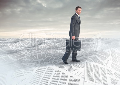 Businessman with briefcase in sea of documents under sky clouds