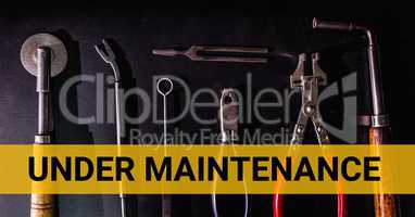 Under maintenance text against tools photo