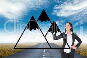 Business woman drawing mountains on the road