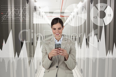 Business woman holding a phone and graphics in server room