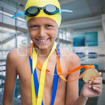 Composite image of portrait of smiling boy showing medal