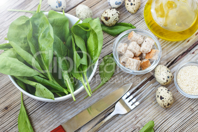Healthy breakfast. Fresh baby spinach leaves. Ingredients for spinach salad with quail eggs