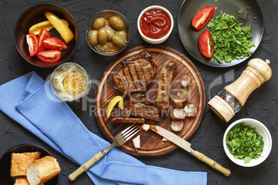 Appetizing barbecue steak at the dinner table in a restaurant with fresh vegetables, olives and wine. Italian Tradition