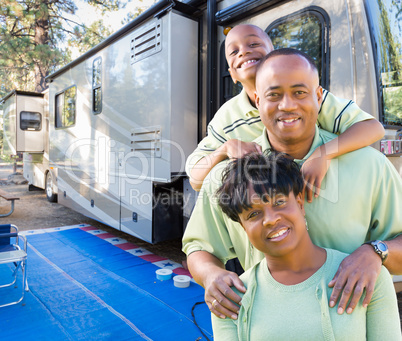 Happy African American Family In Front of Their Beautiful RV At