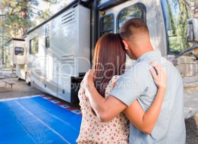Military Couple Looking At A Beautiful RV At The Campground.