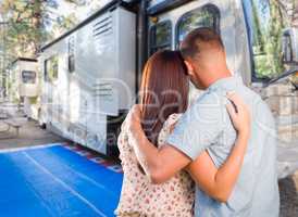 Military Couple Looking At A Beautiful RV At The Campground.