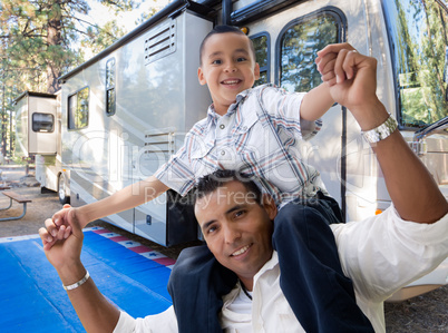 Happy Hispanic Father and Son In Front of Their Beautiful RV At